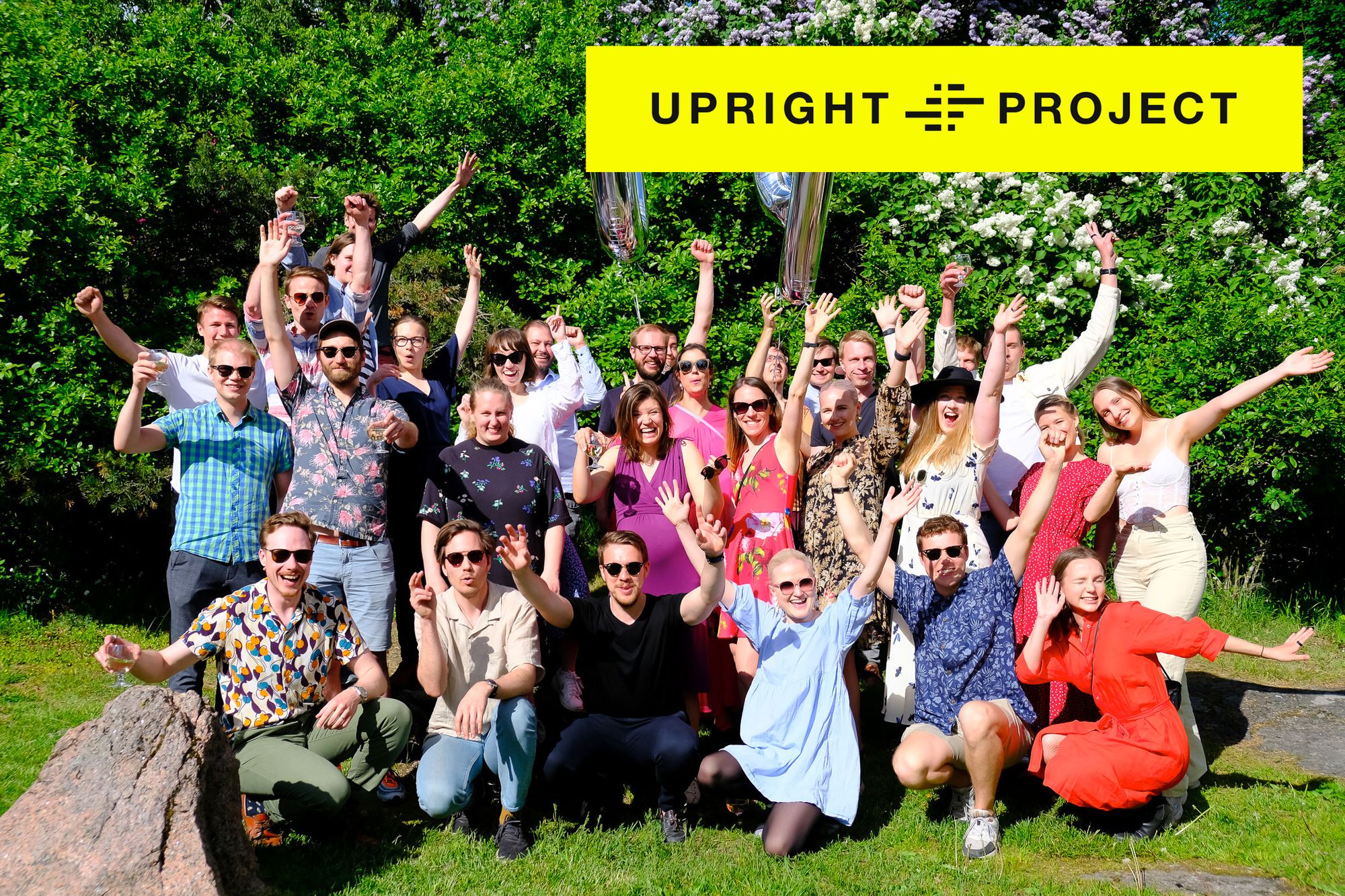 The group photo of the Upright Project team with the company logo